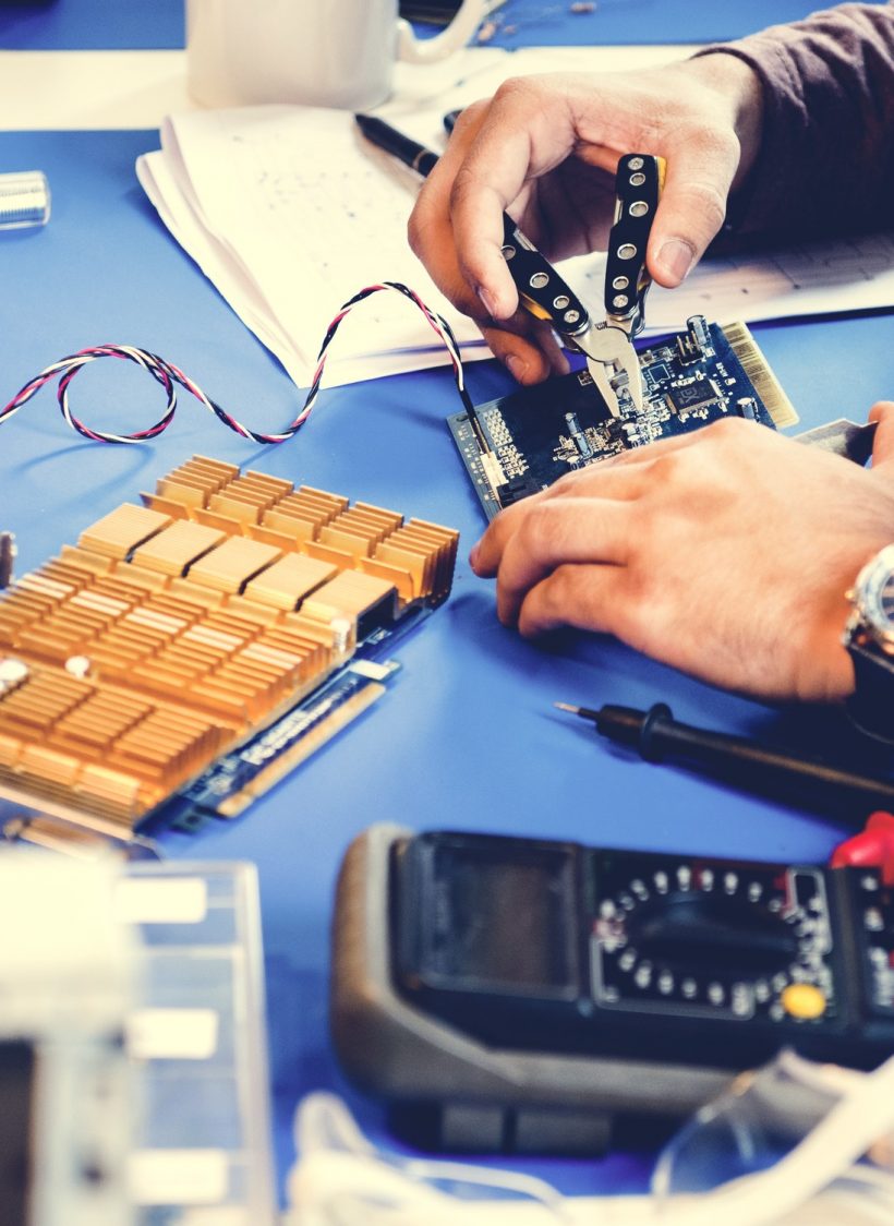 Technicians working on electronics parts